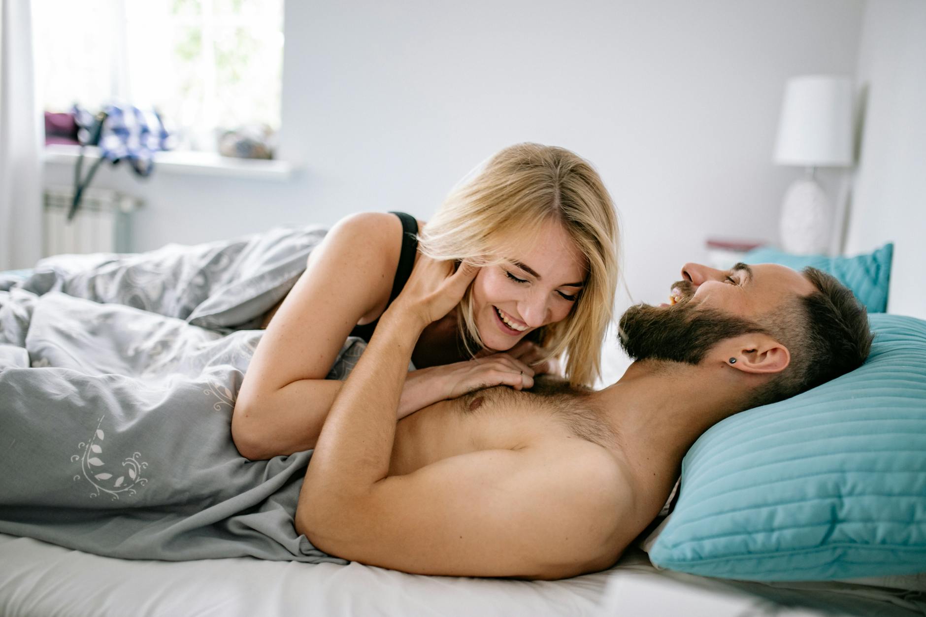couple laughing in bed